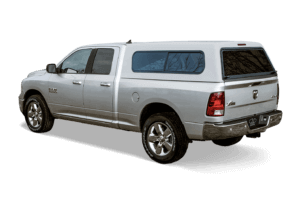 Silver Ram with a cab high truck cap with sliding side windows